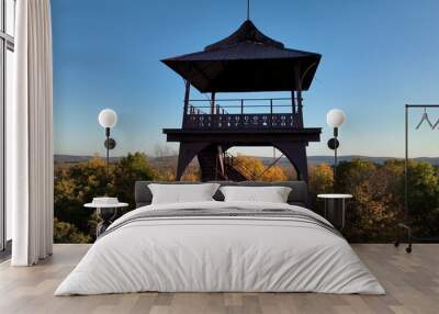 Lookout tower in Pennsylvania mountains during Autumn with Fall colors in trees and clear blue sky Wall mural