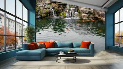 Rockery rocks in the beautiful garden and boutique koi in the pond Wall mural