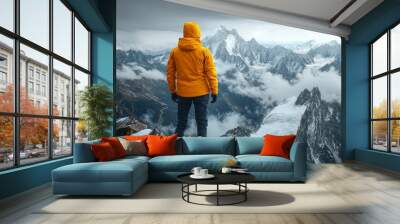 Wide shot of hiker in the mountains. Standing in the distance with his back turned away from us, overlooking vast snow-covered mountain range.	
 Wall mural