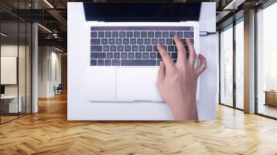 Woman hand pressing keyboard shortcut on laptop keyboard Wall mural