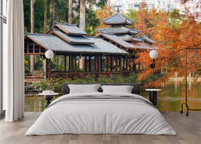 Yellowing trees and ancient Chinese pavilions in the autumn park Wall mural