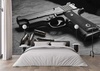 A sleek black handgun displayed on a dark surface with several metallic bullets arranged nearby, emphasizing weaponry aesthetics. Wall mural