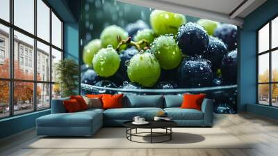 A bowl filled with black and green grapes, each covered in water droplets, looking fresh and ready to eat   Wall mural