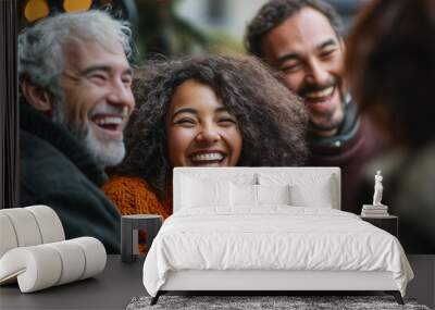 A diverse group of friends, including an African American woman and two white men, share laughter and joy outdoors on a cool day, wearing cozy sweaters. Wall mural