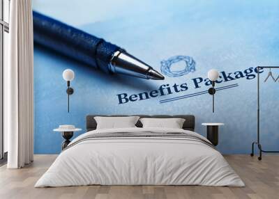 A pen rests on a benefits package document, symbolizing important decisions and employee satisfaction. The blue-toned background creates a professional and trustworthy atmosphere Wall mural