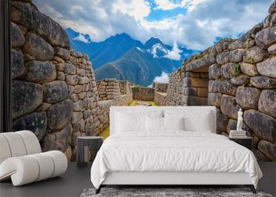 Ancient stone ruins of Machu Picchu with a breathtaking backdrop of Andean mountains under a partly cloudy sky, highlighting the historical architecture and natural beauty. Wall mural