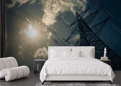 an electricity pylon stands tall in the hot summer sun with a few wispy clouds. solar power concept. Wall mural