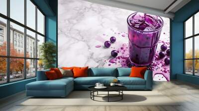 purple drink being poured into glass cup fruity summer refreshment white marble background  Wall mural