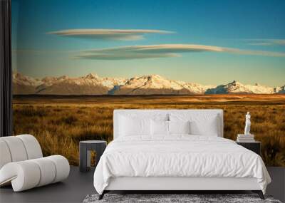 Snow covered  Southern Alps with Lenticular clouds taken from the rural landscape of the Tekapo to Twizel road Wall mural