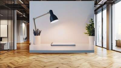 A minimalist workspace with a clean desk, a single lamp, and a notebook Wall mural