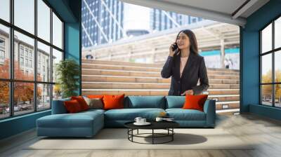 Young beautiful businesswoman talking on the phone. Wall mural