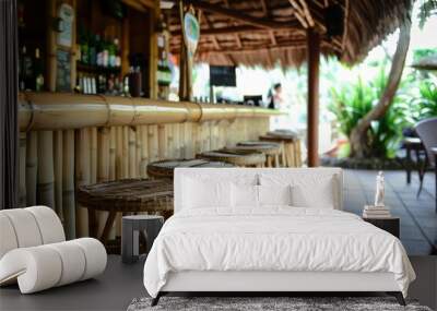 bar area with bamboo stools and thatched roof detail Wall mural