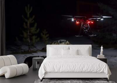 night shot of the drone equipped with lights tracking coyotes Wall mural