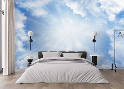 Rays of light shining in blue sky clouds Wall mural