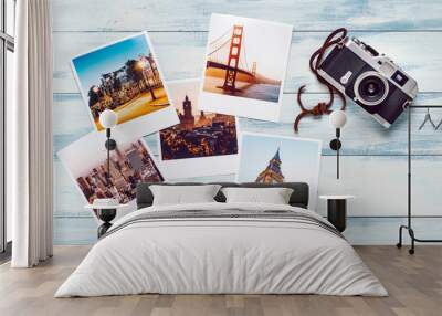 Photographic prints and camera on colored wooden panel Wall mural