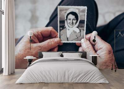 CIRCA 1970: Elderly woman hands holding vintage, black and white photo Wall mural