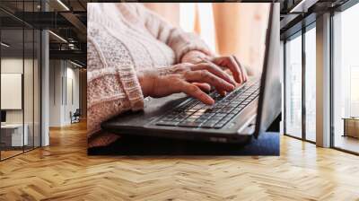 Elderly woman hands typing on the keyboard. Quarantine life Wall mural