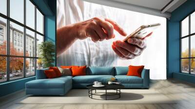 Older woman hands. Using touch screen phone. Old people and technology Wall mural