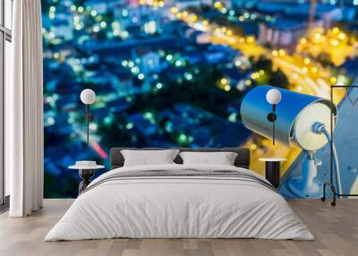 cctv camera or surveillance operating in night time with city bl Wall mural