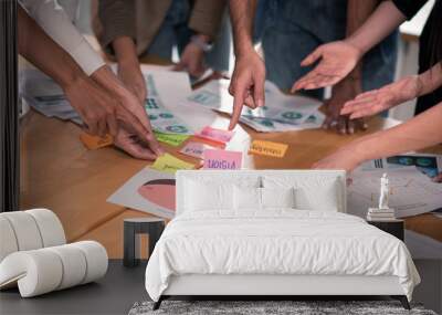 Hands of six people on meeting table point and brainstorming on post it paper and chart Wall mural