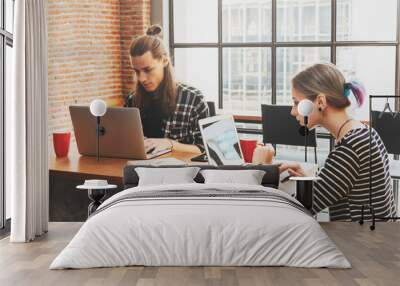 Two freelance working in coffee shop, Nomad worker conceptual, couple work together in cafe with laptop and smartphone Wall mural