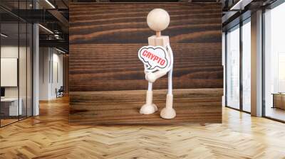 CRYPTO Concept. Miniature man with speech bubble in hands on wood texture background Wall mural