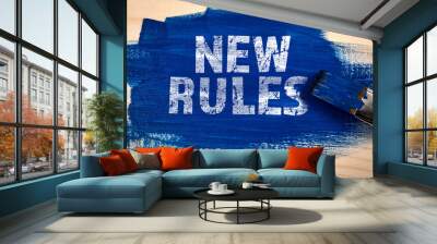 NEW RULES. Blue paint and paint brush on wooden texture background Wall mural