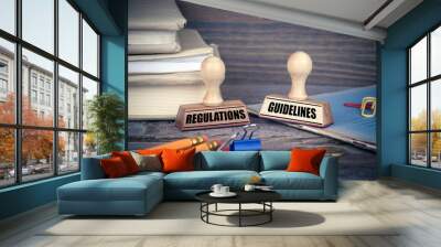 Regulations and Guidelines concept. Rubber Stamp on desk in the Office. Business and work background. Wall mural