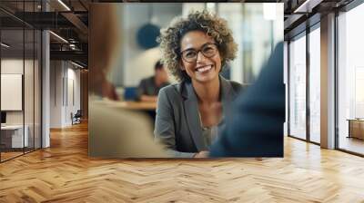 Happy African American mature middle 60s aged smiling lady boss manager talking to colleagues meeting in office space. Team leader portrait of company team working together in modern office. Closeup Wall mural