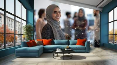 In a modern office environment a Muslim woman leads a diverse team during a corporate workshop surrounded by technology and abstract polygonal designs Wall mural