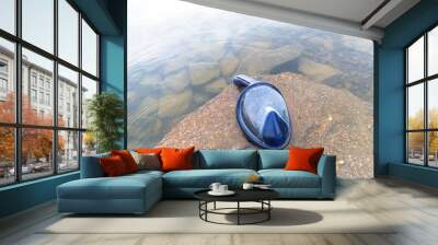 Diving mask ob a rock by the lake summer vacation adventure, diving fun, copy space summer background Wall mural