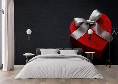 Red gift box with silver ribbon. Black background. Smooth surface. Copy space. Valentines idea Wall mural