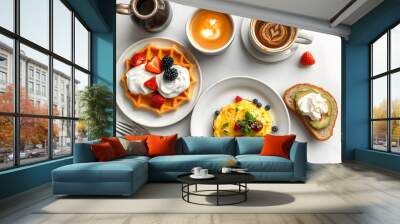 Morning breakfast on a table above, waffles with cream, berries, coffee, cappuccino, bowl, omlet with vegetables, bread with butter, avocado cream, vegan food, healthy food, meal isolated with white Wall mural