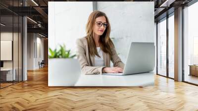 Beautiful Businesswoman typing on laptop Wall mural