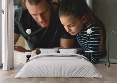 Father and daughter looking at mobile phone Wall mural