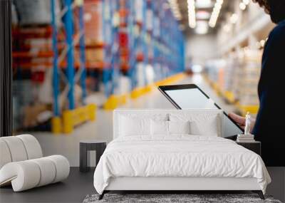 Manager in warehouse holding digital tablet Wall mural