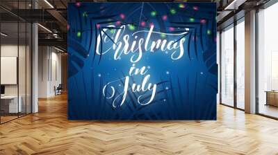 Christmas in July. Tropical background with exotic palm leaves, Christmas lights and lettering. Summer Christmas banner Wall mural