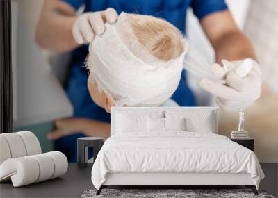 Sports injury. Doctor makes bandage on head patient, in the hospital. Wall mural