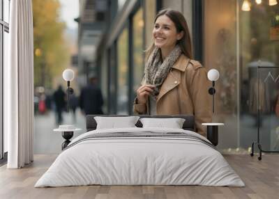 Happy woman with shopping bags looking at store windows while walking through city Wall mural