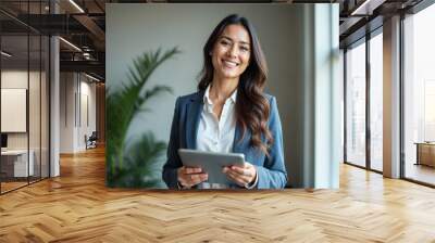 Portrait of young Hispanic professional business woman standing in office. Happy female company executive, smiling businesswoman entrepreneur corporate leader manager looking at camera using tablet Wall mural