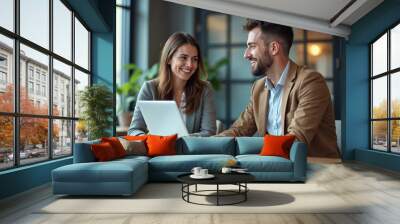 Two busy happy professional business man and woman executive leaders team using laptop working on computer at work desk having conversation on financial project at meeting in office Wall mural