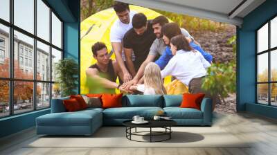 Group of young teenagers tent camping picnic cooking on his vacation. Wall mural