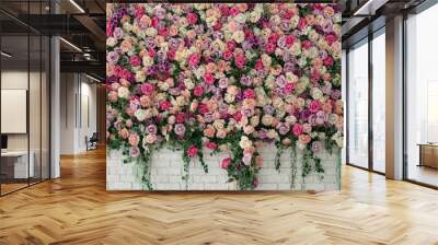 Beautiful decorative colorful roses and peonies on brick white wall. Interior wedding party decor. Wall with curly Flowers. Brick wall with beautiful flowers in room. Summer flowers on wall building.  Wall mural