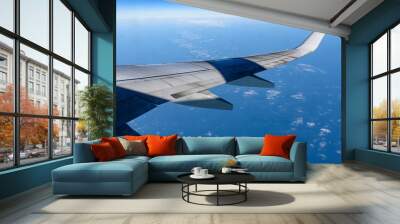 View from the elluminator of the aircraft on a sunny day on the city from above, blue sky with clouds. Wall mural