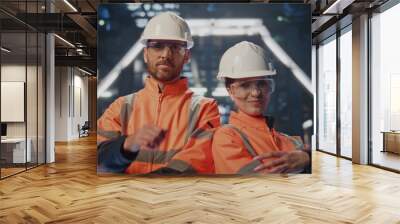 Professional factory workers posing at modern heavy industry factory close up. Wall mural