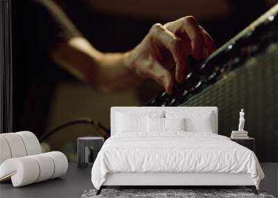 Unrecognizable person preparing equipment in studio. Man hand turning knobs. Wall mural