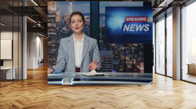 Woman host presenting newscast standing tv stage near screen. Lady breaking news Wall mural