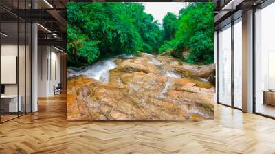 Beautiful waterfall and sedimentary rock on nature background. Wall mural