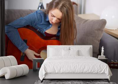 woman play guitar at home Wall mural