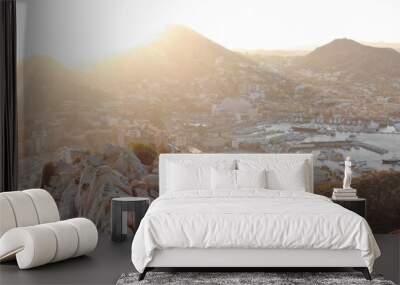 Aerial of cross in cliffs above bay in Cabo San Lucas, Mexico at sunset Wall mural